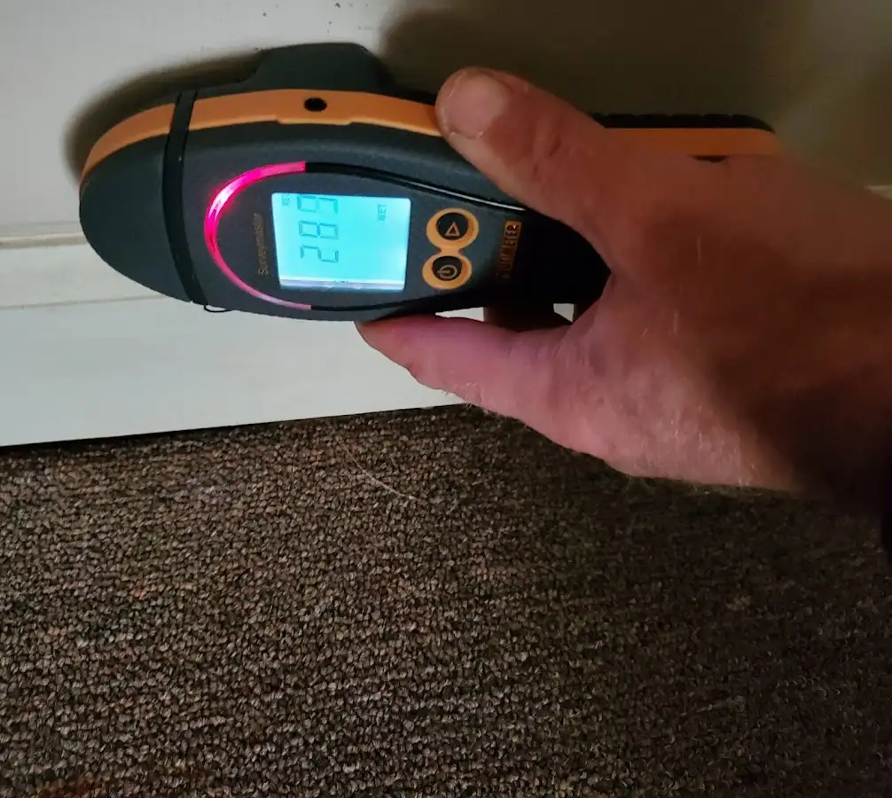 Moisture detection at baseboard during Storm Damage Restoration in Midway